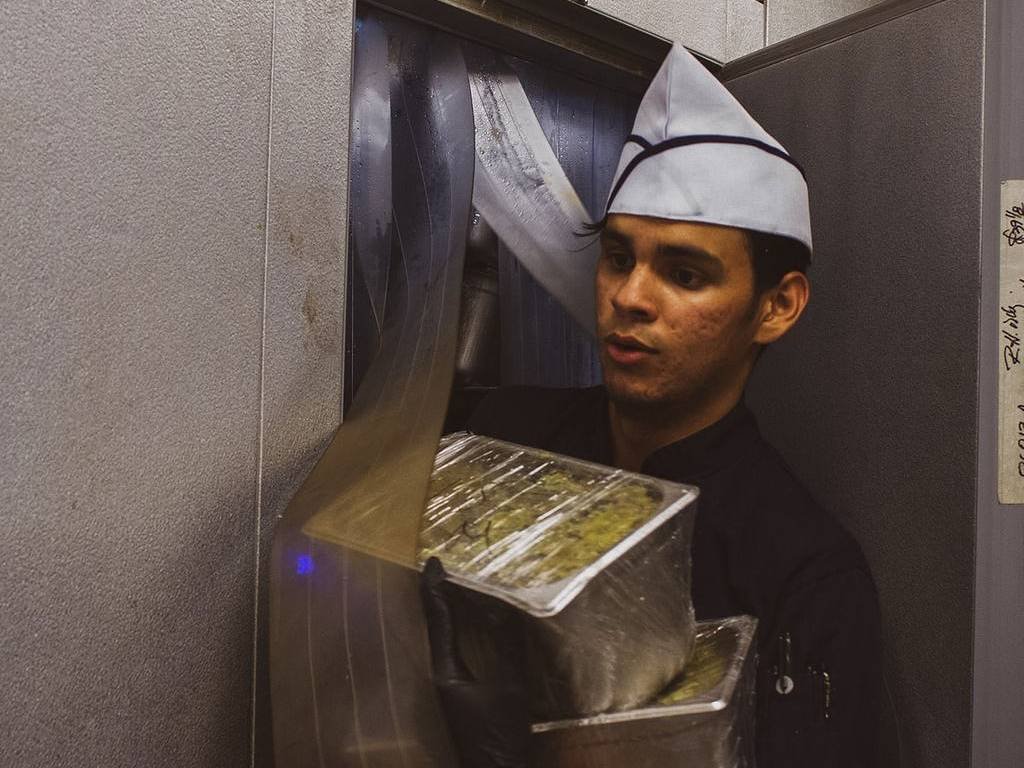 Yonsi walking out a walk in freezer