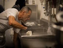 Jorge leaning over a sink