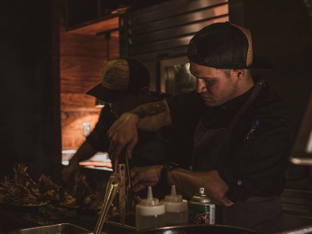Dark scene of Esteban working on a plate