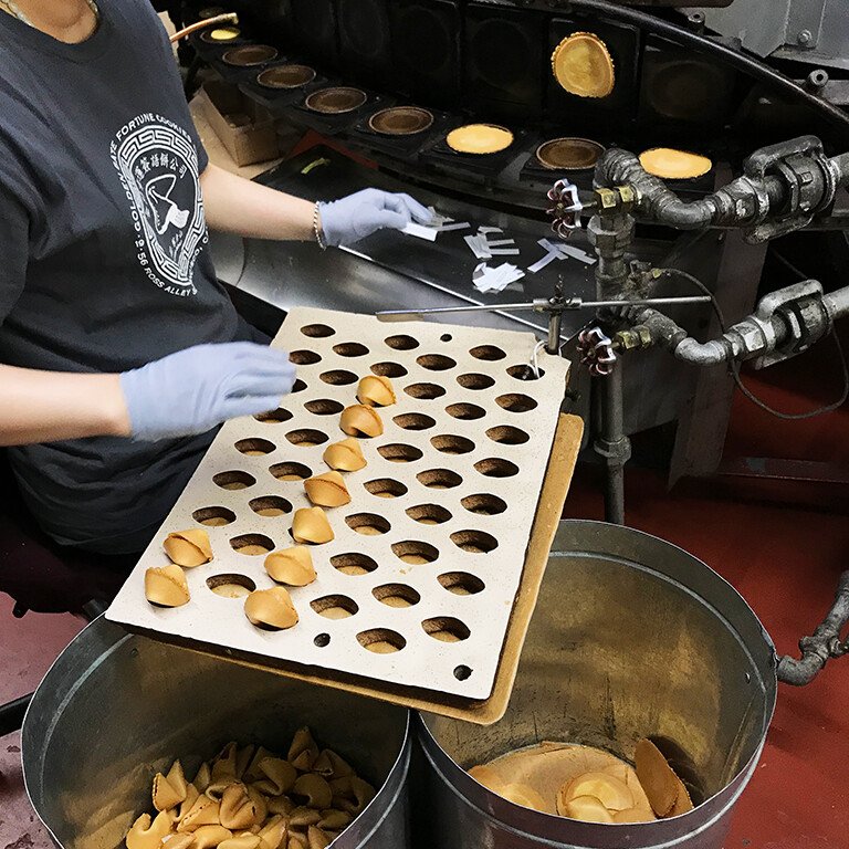 person working on a machine that makes Chinese cookies
